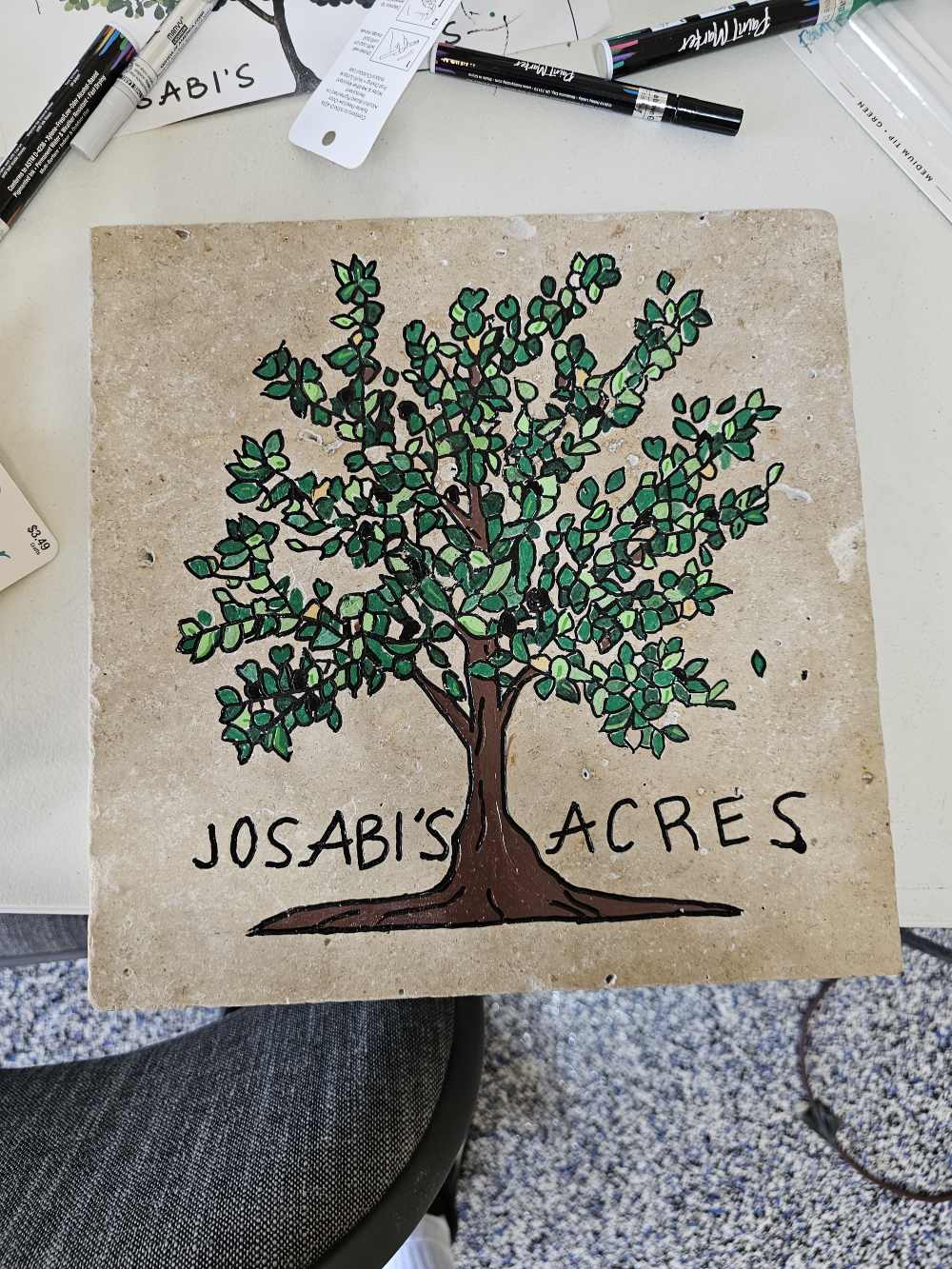 A tile with the name of a tree on it.