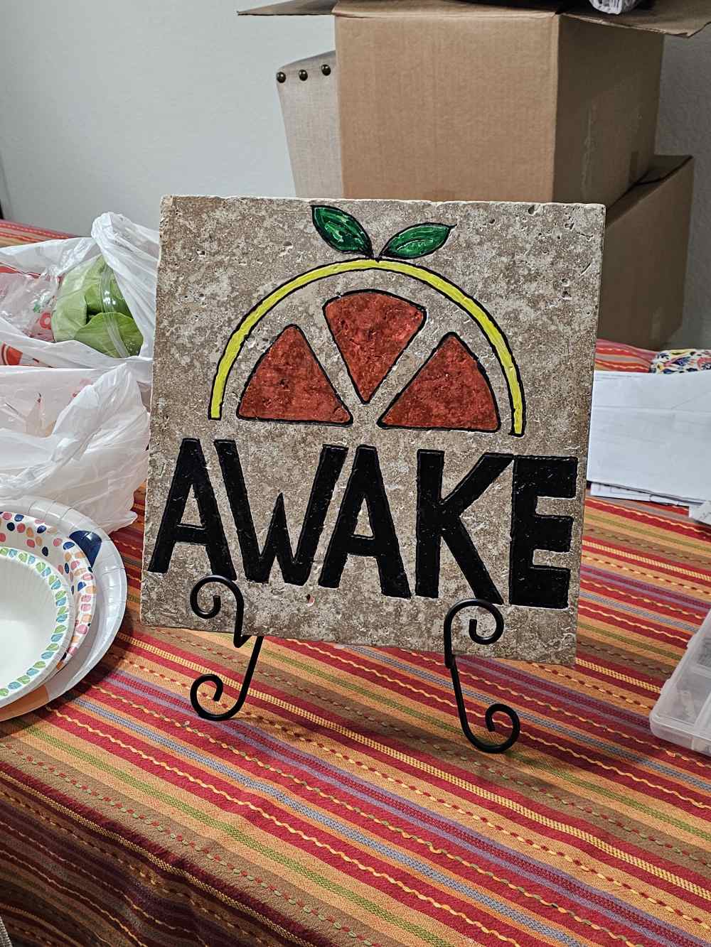 A tile with the word awake written on it.