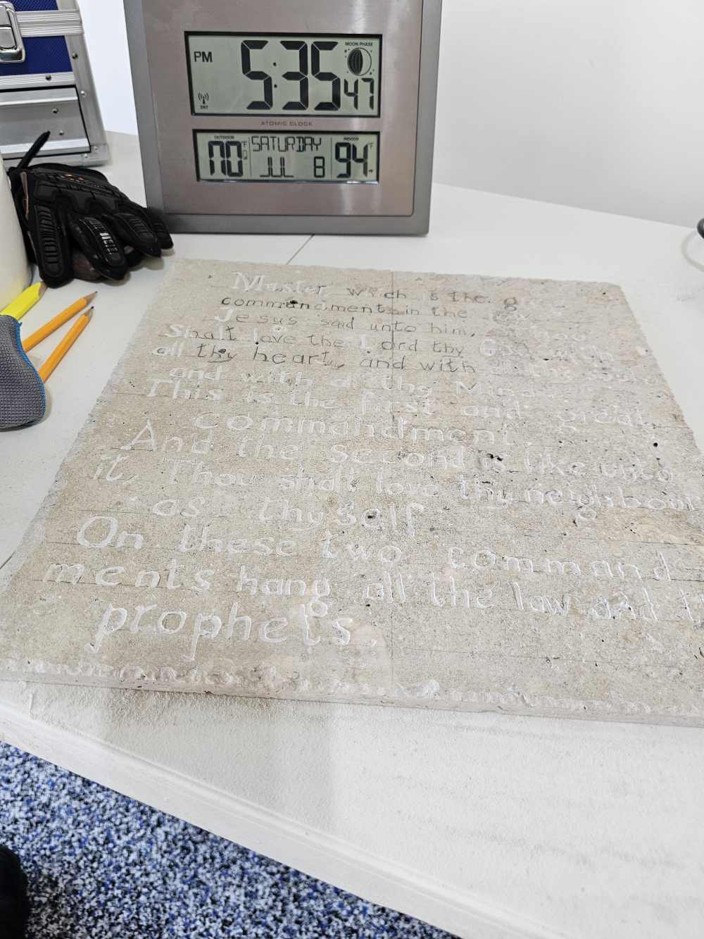 A white table with a clock and some writing on it