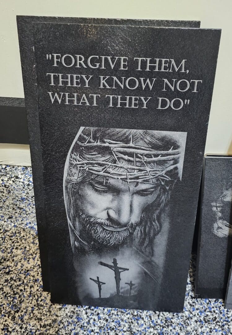 A sign with jesus and the words " forgive them, they know not what they do ".