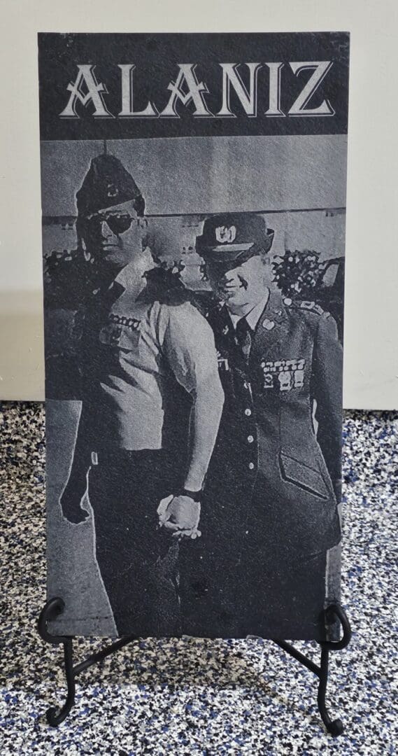 A black and white photo of two men holding hands.