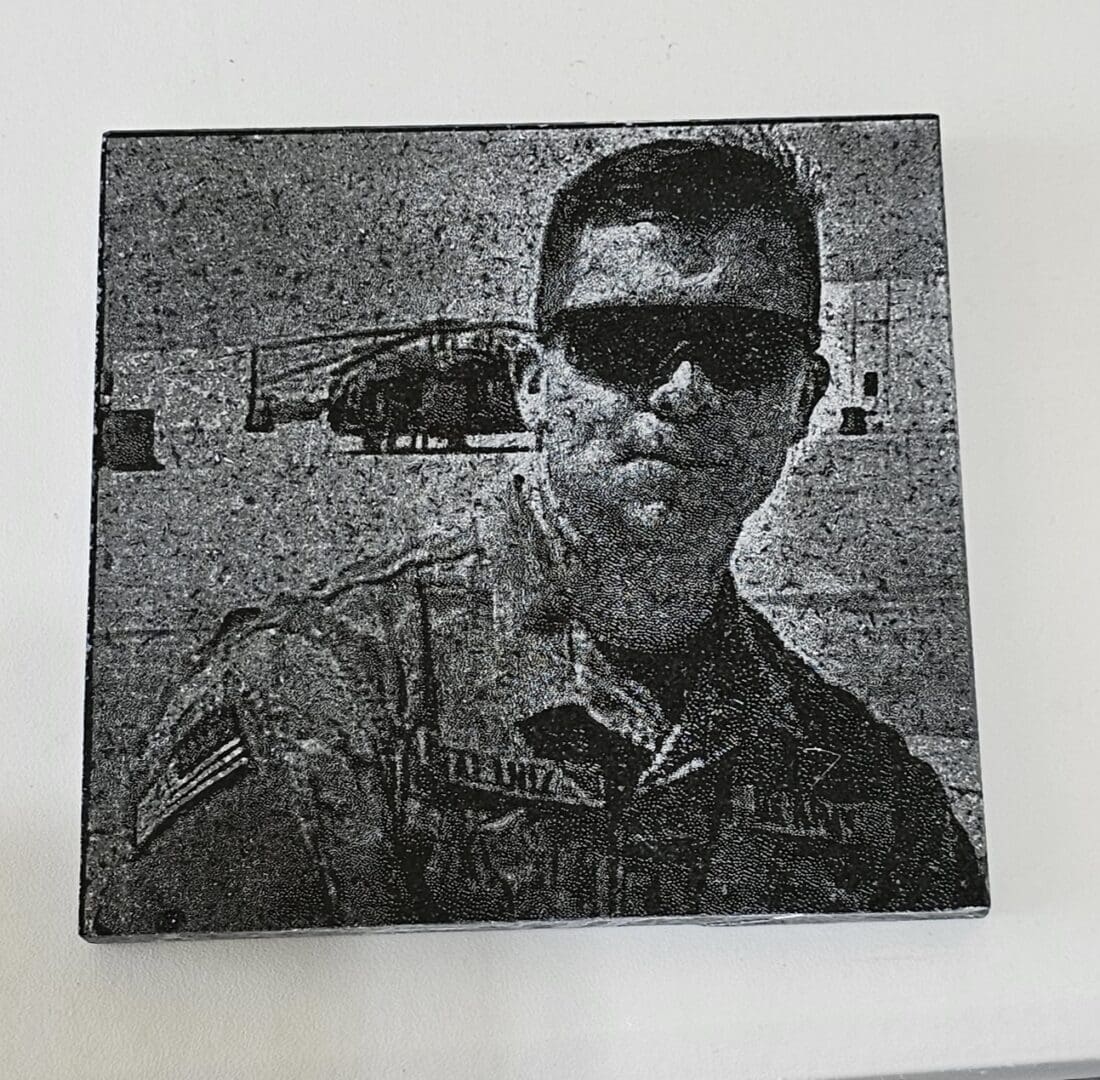 A black and white poster of a person from army wearing googles.